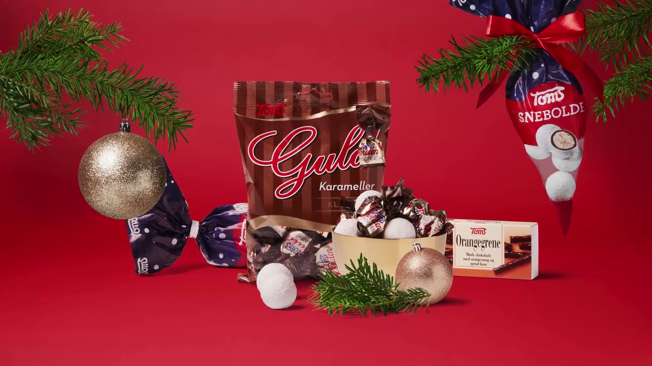 Red Christmas TV spot for Toms: advent-calendar numbers float in snow, door 24 opens onto a festive packshot of Guld Karameller, Ris Kugler and Flødeboller between baubles and pine, and the Toms logo closes on "Husk julehyggen".
